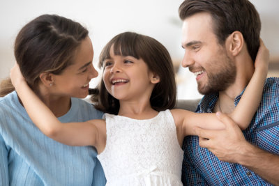 couple with their daughter smiling