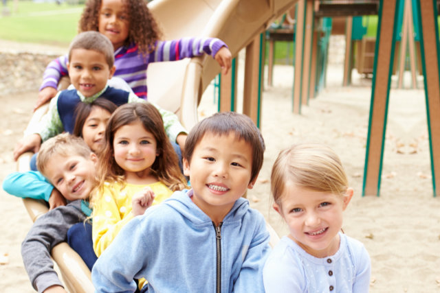diverse kids playing on playground